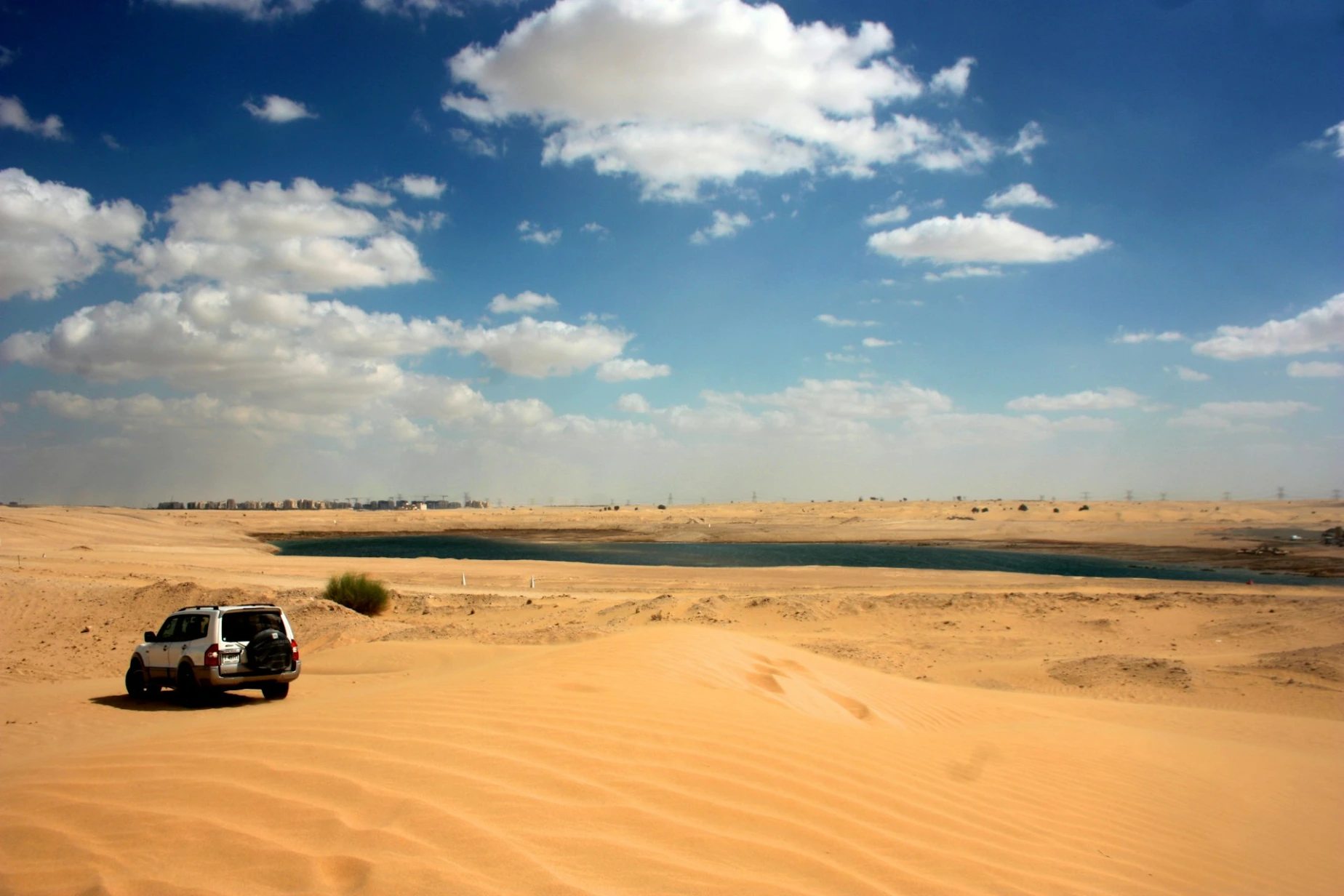 gray SUV on sand dunes during daytime